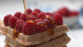 Pouring syrup onto waffles with berries in super slow motion, shot on Phantom Flex 4K video