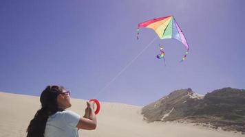 Young girl flying kite at beach video