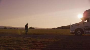 Truck driver walking to truck at sunset.  Fully released for commercial use. video