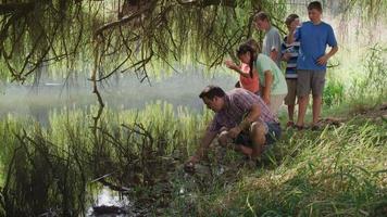 Kids at outdoor school get water samples from pond video