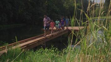 Kids at summer camp follow leader across dock video