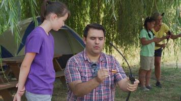 Kids at summer camp doing archery video