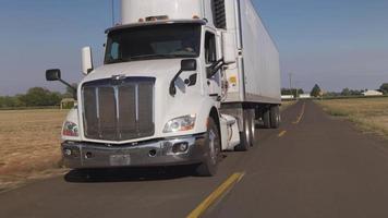 Semi truck driving on rural road.  Fully released for commercial use. video