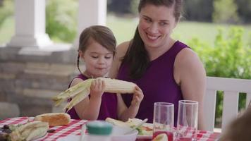 Mother and daughter enjoying dinner at backyard barbeque video