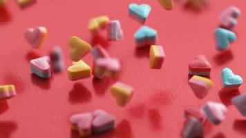 Valentine's Day heart shaped candy falling and bouncing in slow motion. Shot on Phantom Flex 4K. video