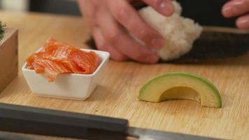Sushi chef preparing sushi rolls video
