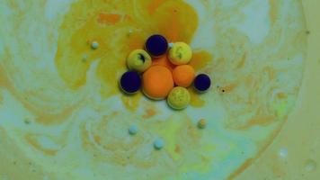 Abstract close up texture of oil with green, orange and blue paint video