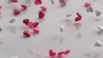 Valentine's Day heart shaped candy falling and bouncing in slow motion. Shot on Phantom Flex 4K.