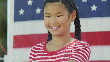 Girl waving sparkler on Fourth of July video