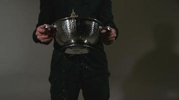 Chef with colander full of peppers splashing in super slow motion, shot with Phantom Flex 4K video