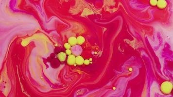 Abstract close up texture of oil with red, yellow and pink paint video