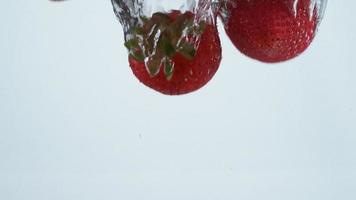 Slow motion shot of strawberries splashing into water, shot with Phantom Flex 4K camera. video