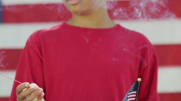 Boy with sparkler and flag on Fourth of July video