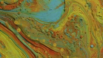 Abstract close up texture of oil with orange, yellow and blue paint video