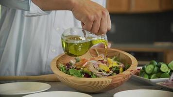 Preparing a salad with fresh vegetables and oil video