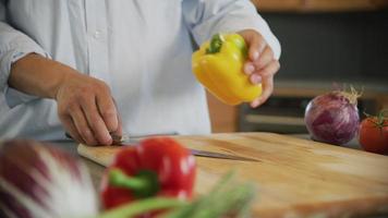 Close up shot of man cutting yellow bell pepper video