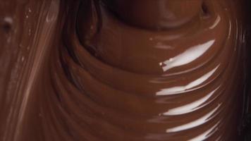Melted chocolate pouring in a candy factory video