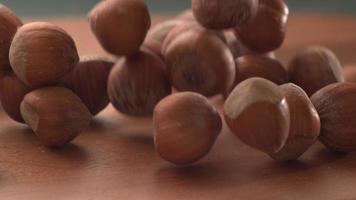 Hazelnuts falling onto wooden surface in super slow motion.  Shot on Phantom Flex 4K high speed camera. video
