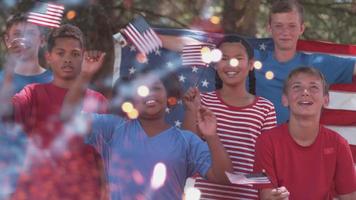 Kids watching fireworks and waving flags on Fourth of July video