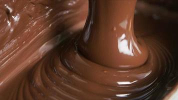 Melted chocolate pouring in a candy factory video