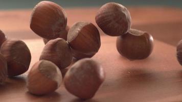 Hazelnuts falling onto wooden surface in super slow motion.  Shot on Phantom Flex 4K high speed camera. video