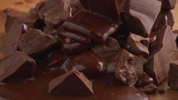 Melted chocolate pouring over chunks of chocolate video