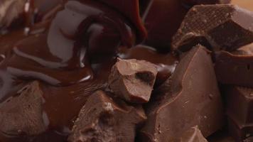 chocolate derretido vertido sobre trozos de chocolate video