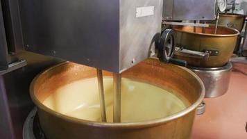 Mixing ingredients for chocolate fudge at candy factory video