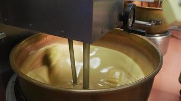 Mixing ingredients for chocolate fudge at candy factory