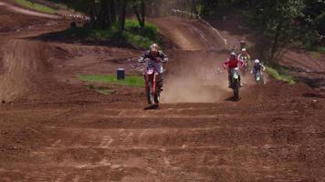 Motocross racers going over big jump in slow motion 4K fully released video