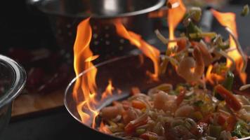 Stir fry into flaming pan in super slow motion shot on Phantom Flex 4K video
