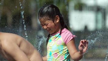 Girl playing in fountain, Slow motion video