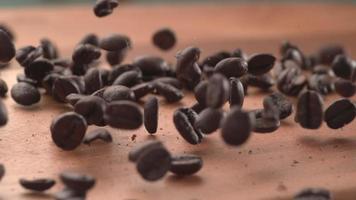 Coffee beans falling onto wooden surface in super slow motion.  Shot on Phantom Flex 4K high speed camera. video