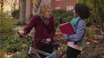 Two college students on campus talking video