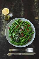 Green pea pods with chilli and sesame photo