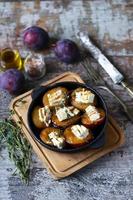 Baked plums with white cheese photo