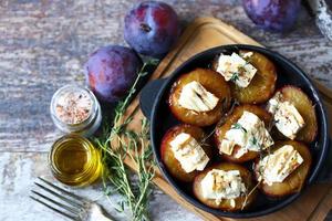 Baked plums with white cheese photo