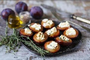 Baked plums with feta cheese photo