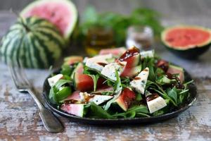 Watermelon salad with arugula and gorgonzola cheese photo