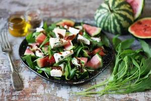 Watermelon salad with arugula and gorgonzola cheese photo