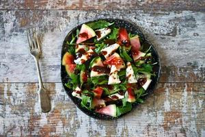 Watermelon salad with arugula and gorgonzola cheese photo