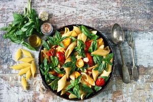 Pasta in a pan with tomatoes basil and spices One pan pasta photo