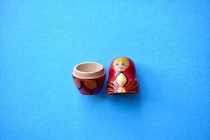 red matrioshka doll on the blue background photo