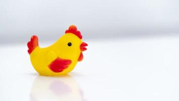 Close up of Little toy chicken sitting on isolated white background photo