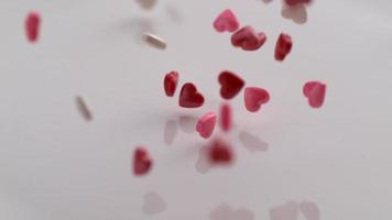 Valentine's Day heart shaped candy falling and bouncing in slow motion. Shot on Phantom Flex 4K. video