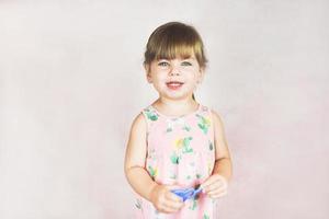 Young little and funny girl in a studio shot photo