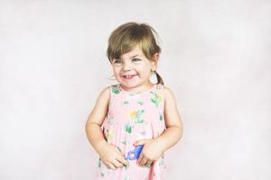 Young little and funny girl in a studio shot photo