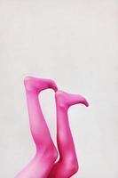 Female legs wearing pink tights photo