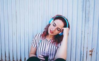 Beautiful redhead woman listening to music photo