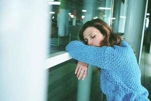 Young woman alone and tired in a bus station photo